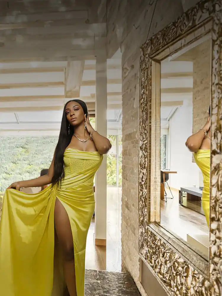 Yellow satin dress with high slit and ruched bodice.